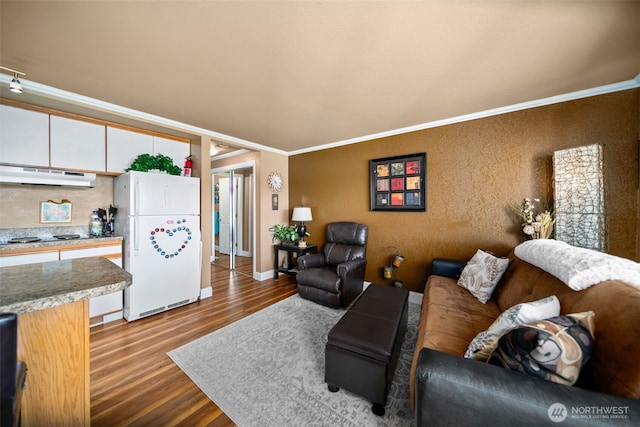 living area featuring ornamental molding, dark wood finished floors, and baseboards