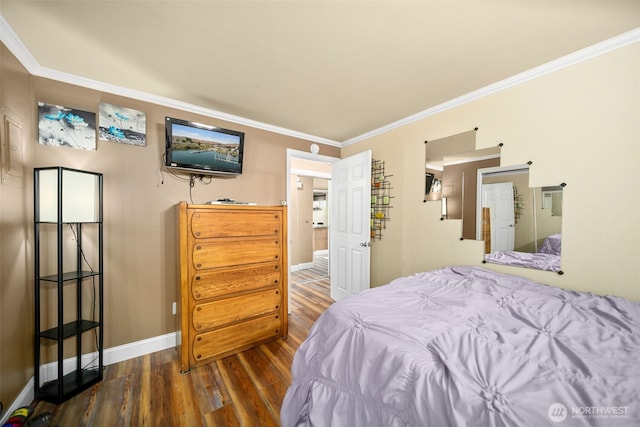 bedroom with wood finished floors, ornamental molding, and baseboards