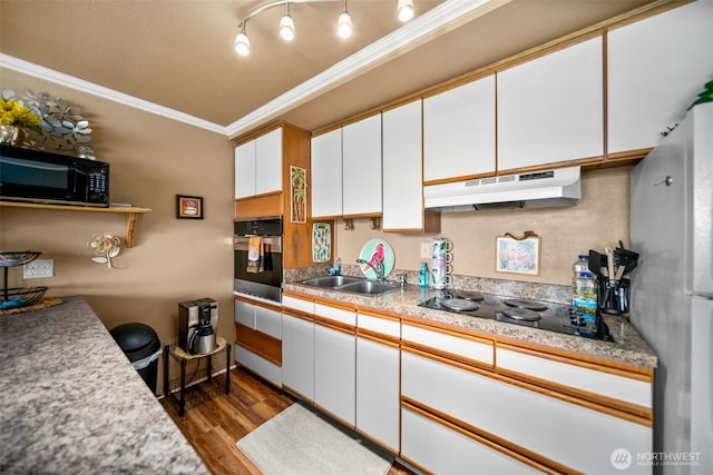 kitchen featuring under cabinet range hood, black appliances, crown molding, dark wood-style flooring, and white cabinetry