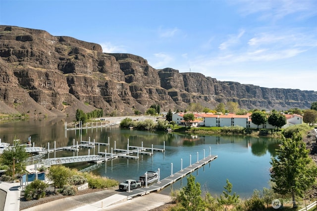 dock with a water and mountain view and boat lift