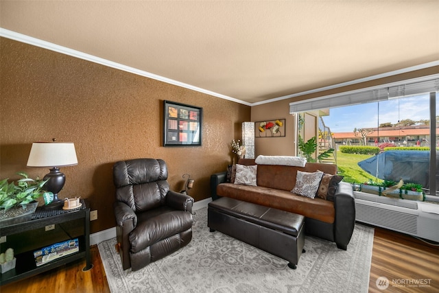 living area featuring ornamental molding, wood finished floors, and baseboards