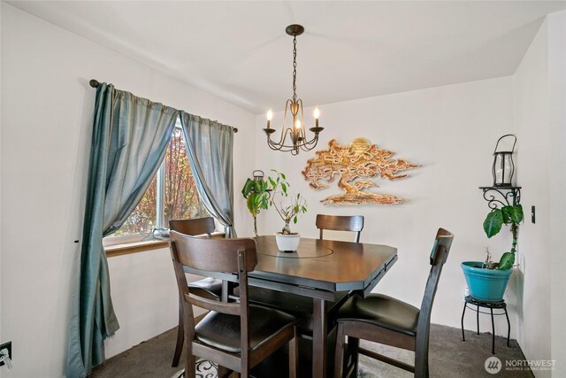 dining room featuring an inviting chandelier and carpet floors