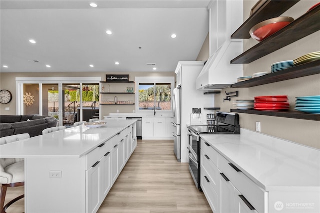 419 Edgewater Way SW, Mattawa, WA 99349 - kitchen with open shelves, stainless steel appliances, a kitchen island, recessed lighting, and white cabinets