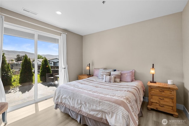 419 Edgewater Way SW, Mattawa, WA 99349 - bedroom featuring wood finished floors, access to exterior, recessed lighting, baseboards, and a mountain view