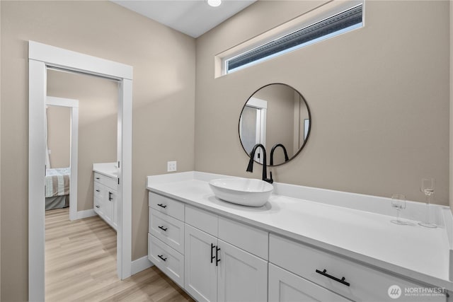 419 Edgewater Way SW, Mattawa, WA 99349 - ensuite bathroom featuring vanity, wood finished floors, and baseboards