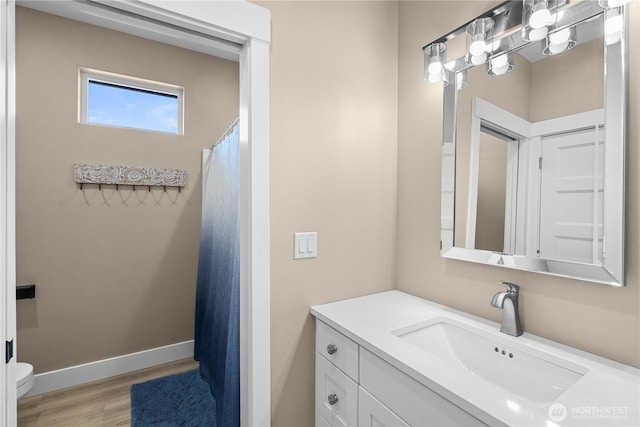 419 Edgewater Way SW, Mattawa, WA 99349 - bathroom featuring wood finished floors, vanity, toilet, and baseboards