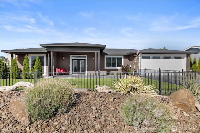 419 Edgewater Way SW, Mattawa, WA 99349 - view of front of home with an attached garage, stucco siding, french doors, a shingled roof, and driveway