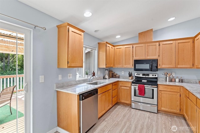 592 Kodiak Ave, Camano Island, WA 98282 - kitchen with lofted ceiling, light brown cabinetry, appliances with stainless steel finishes, a sink, and light wood-type flooring