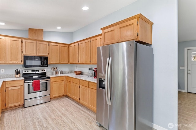 592 Kodiak Ave, Camano Island, WA 98282 - kitchen featuring light brown cabinets, light stone countertops, recessed lighting, light wood-style floors, and appliances with stainless steel finishes
