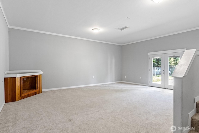 592 Kodiak Ave, Camano Island, WA 98282 - unfurnished living room with baseboards, ornamental molding, french doors, and light colored carpet
