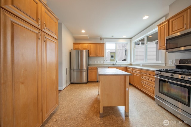 703 18th Ave S, Seattle, WA 98144 - kitchen featuring stainless steel appliances, light countertops, a center island, a sink, and recessed lighting