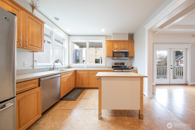 703 18th Ave S, Seattle, WA 98144 - kitchen with appliances with stainless steel finishes, a sink, light countertops, a kitchen island, and recessed lighting