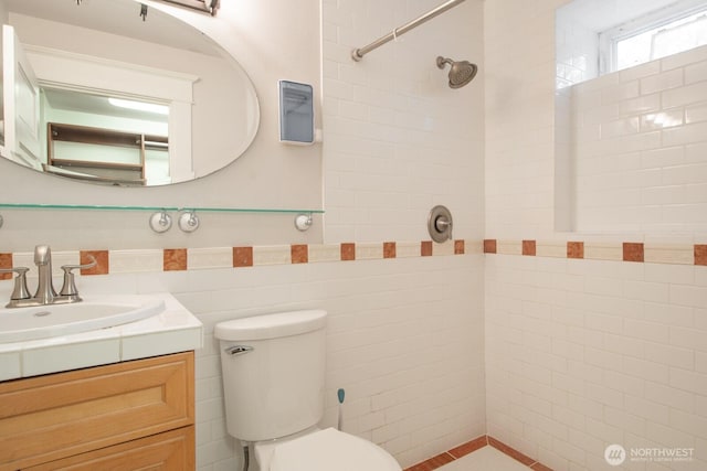 703 18th Ave S, Seattle, WA 98144 - full bathroom with tiled shower, vanity, toilet, tile walls, and wainscoting