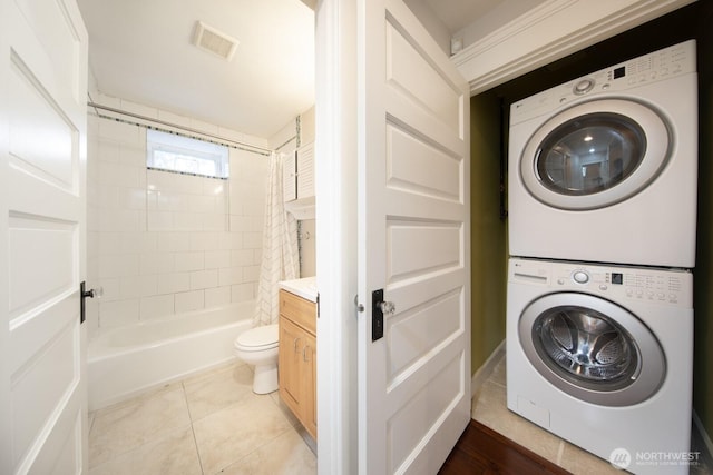 703 18th Ave S, Seattle, WA 98144 - clothes washing area featuring stacked washer / dryer and light tile patterned floors