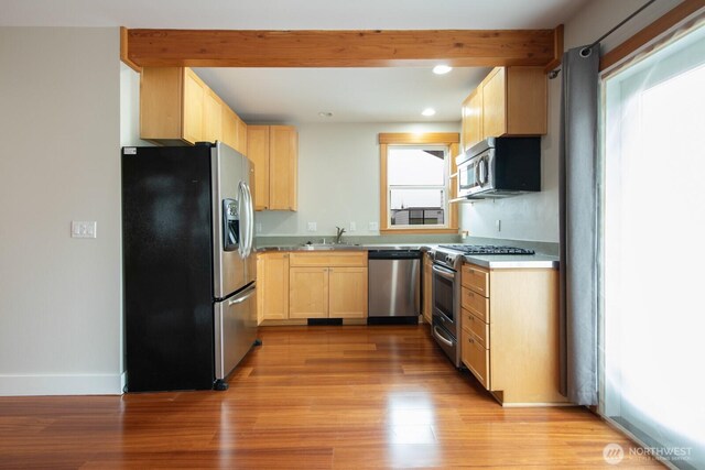 703 18th Ave S, Seattle, WA 98144 - kitchen with appliances with stainless steel finishes, light brown cabinets, light wood finished floors, recessed lighting, and baseboards