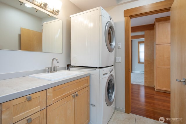 703 18th Ave S, Seattle, WA 98144 - laundry room featuring stacked washer and clothes dryer, cabinet space, and light tile patterned flooring
