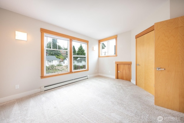 703 18th Ave S, Seattle, WA 98144 - unfurnished bedroom featuring baseboard heating, carpet floors, and baseboards