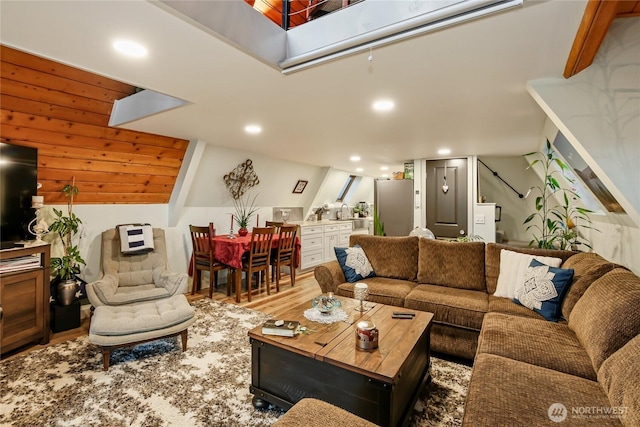 living area with stairway, wood finished floors, and recessed lighting