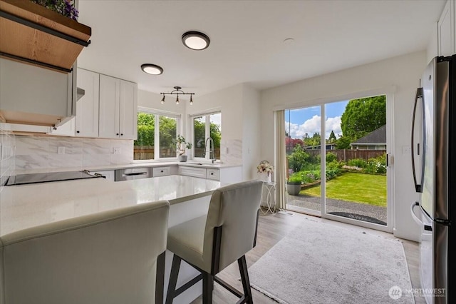 16886 Wales St SE, Monroe, WA 98272 - kitchen with appliances with stainless steel finishes, a sink, healthy amount of natural light, and light countertops