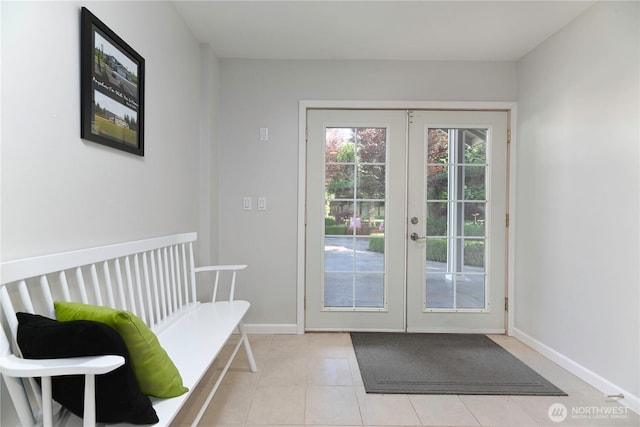 doorway to outside with french doors, baseboards, and light tile patterned flooring