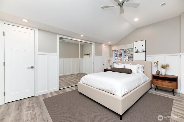 12428 155th Ave NE, Arlington, WA 98223 - bedroom featuring light wood-style flooring, a decorative wall, a wainscoted wall, vaulted ceiling, and ceiling fan