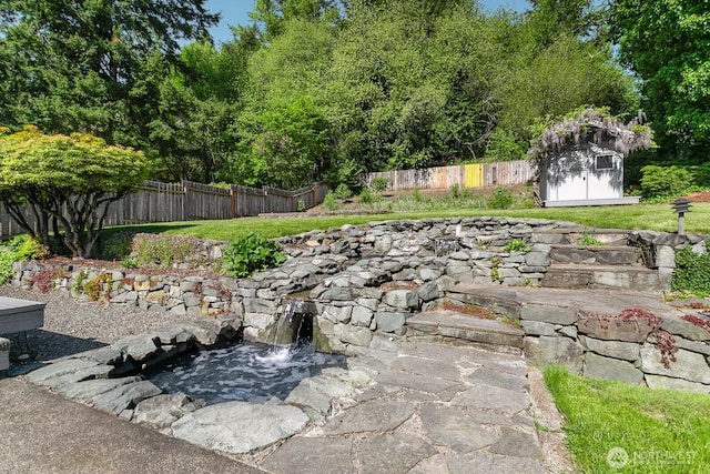 15221 42nd Ave E, Tacoma, WA 98446 - fenced backyard with a storage shed, an outbuilding, and a garden pond