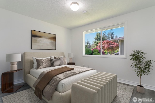 15221 42nd Ave E, Tacoma, WA 98446 - bedroom featuring a textured ceiling, wood finished floors, and baseboards