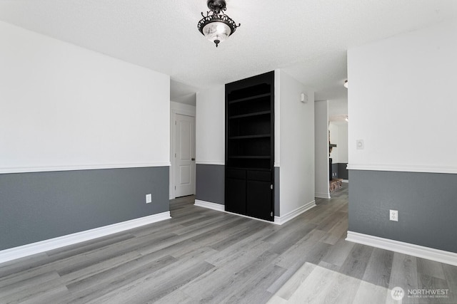 15221 42nd Ave E, Tacoma, WA 98446 - unfurnished room with wood finished floors and baseboards