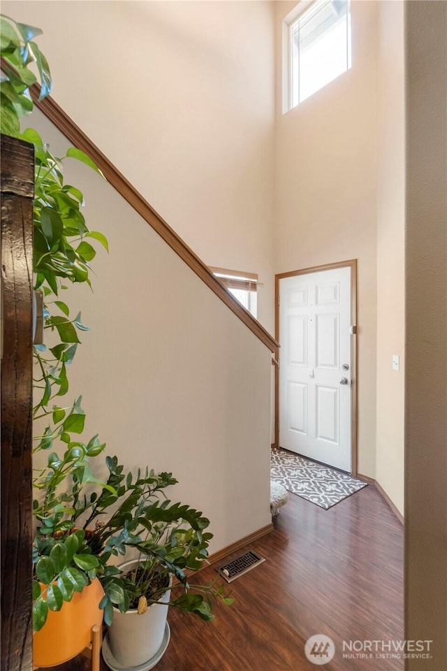 20402 98th Avenue Ct E, Graham, WA 98338 - foyer entrance featuring wood finished floors, a high ceiling, baseboards, and stairs