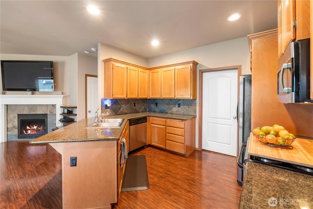 20402 98th Avenue Ct E, Graham, WA 98338 - kitchen with appliances with stainless steel finishes, a sink, dark wood-style flooring, a peninsula, and decorative backsplash