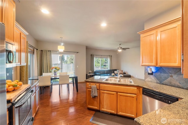 20402 98th Avenue Ct E, Graham, WA 98338 - kitchen featuring appliances with stainless steel finishes, a peninsula, wood finished floors, a sink, and recessed lighting