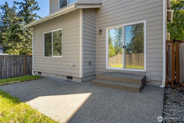 20402 98th Avenue Ct E, Graham, WA 98338 - view of exterior entry with a patio area, fence, and crawl space