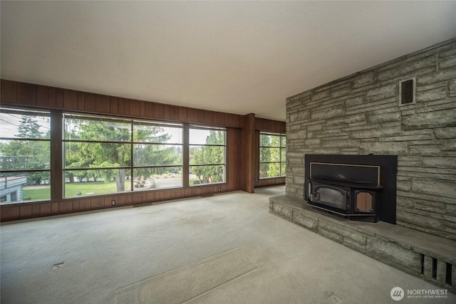 906 E 3rd Ave, Ellensburg, WA 98926 - unfurnished living room with carpet flooring and a wood stove