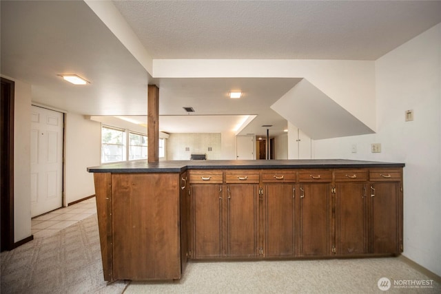 906 E 3rd Ave, Ellensburg, WA 98926 - kitchen with dark countertops, baseboards, and a peninsula