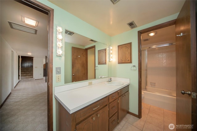 906 E 3rd Ave, Ellensburg, WA 98926 - bathroom with vanity, baseboards, toilet, tile patterned floors, and shower / bath combination with glass door