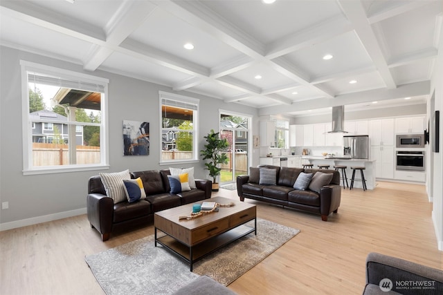 living room featuring coffered ceiling, recessed lighting, plenty of natural light, light wood-style flooring, and beamed ceiling