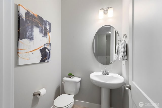 bathroom with toilet and a sink