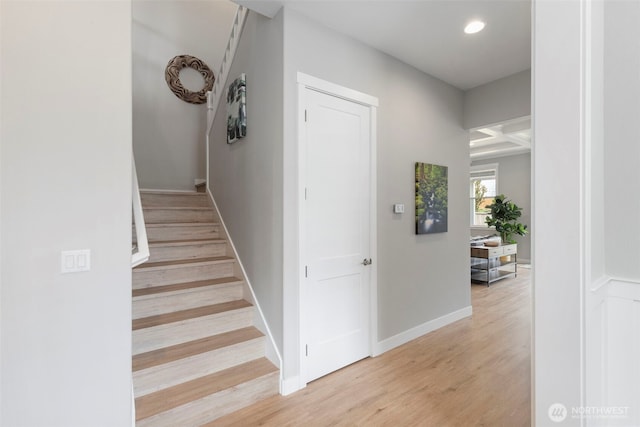 stairway with wood finished floors, recessed lighting, and baseboards
