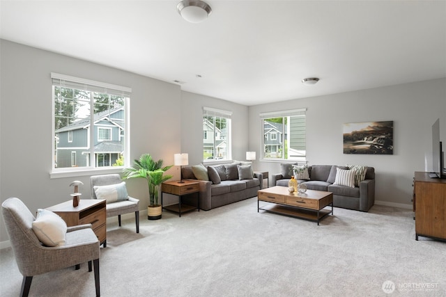 living room featuring plenty of natural light, carpet flooring, and baseboards