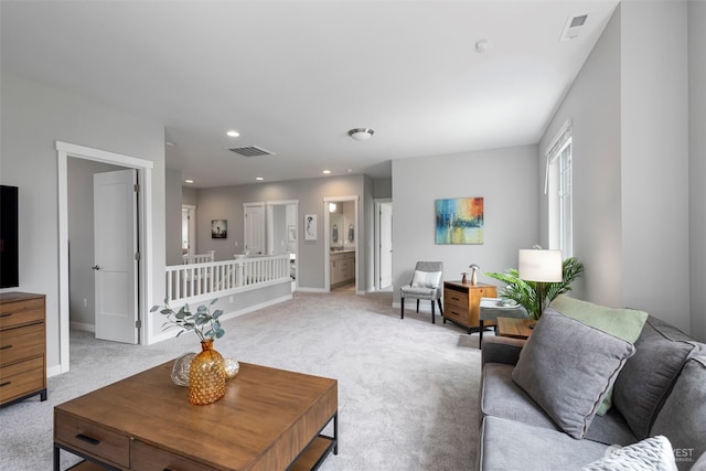 living room with light colored carpet, baseboards, and recessed lighting