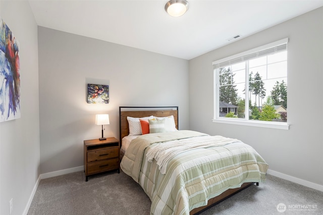 bedroom with carpet floors and baseboards