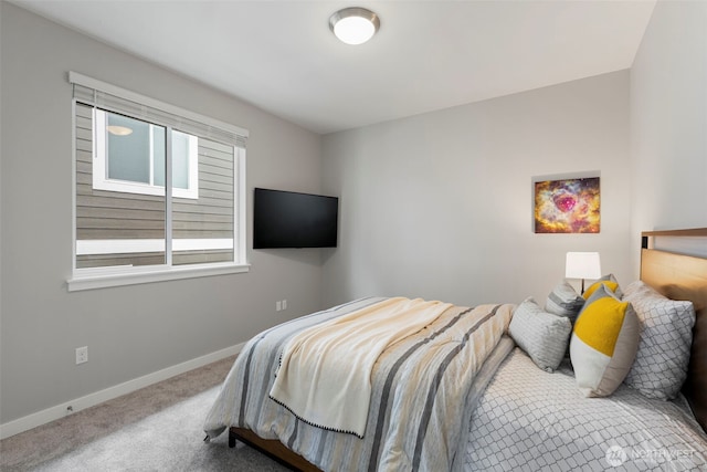 carpeted bedroom featuring baseboards
