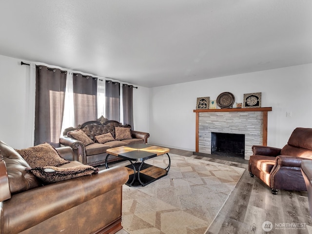 living area with wood finished floors and a fireplace