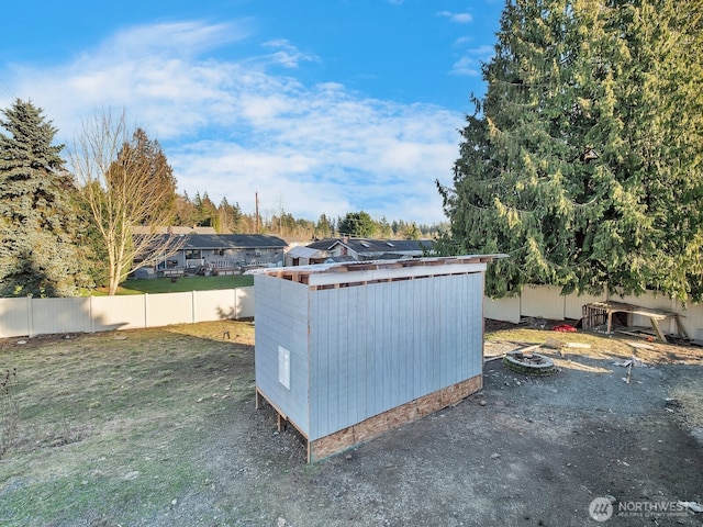 view of yard with an outbuilding, a fenced backyard, and a shed