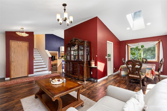 living room with lofted ceiling, a chandelier, wood finished floors, a skylight, and baseboards