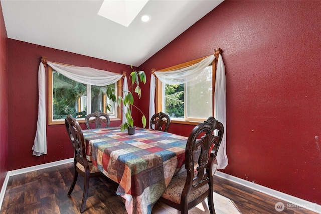 dining area featuring vaulted ceiling, a skylight, wood finished floors, baseboards, and recessed lighting