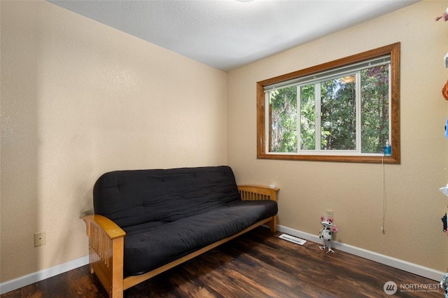 living area with wood finished floors and baseboards
