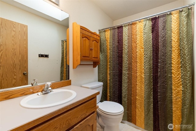 bathroom featuring toilet and vanity