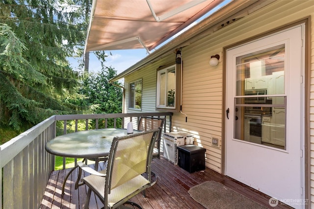 wooden terrace featuring outdoor dining area
