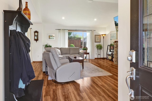 living room featuring baseboards, recessed lighting, and wood finished floors
